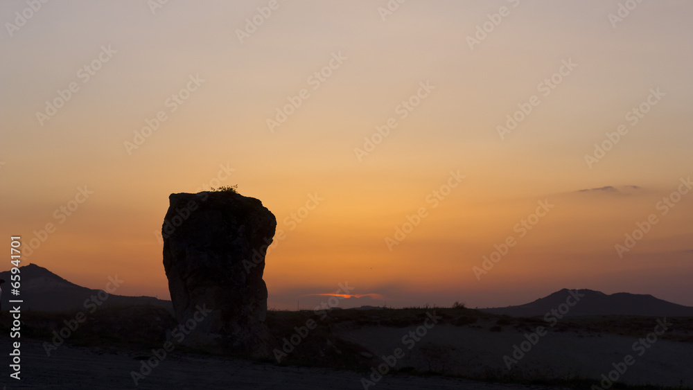 Sunset and a rock