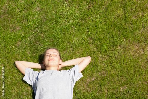 young girl lying on the grass