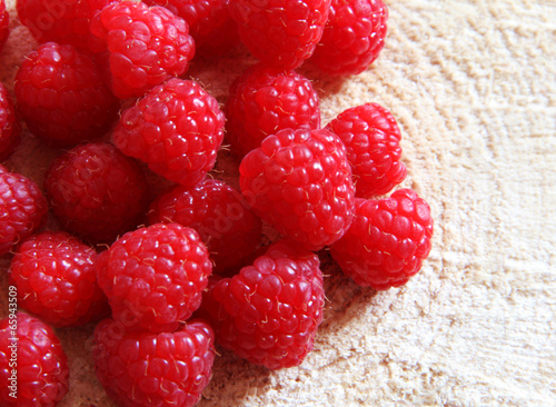 Fresh ripe raspberries on a wooden background