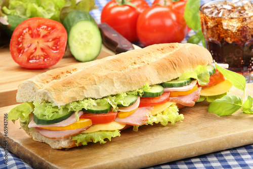 Baguette salad submarine sandwich with ham cheese and tomato on