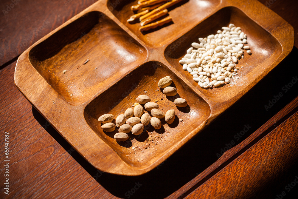 Pistachios, roasted rice and salty sticks in bowl Pistachios, roasted rice and salty sticks in bowl