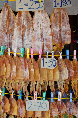 Row of Appetizing Dry Squids for Sale on Street,Thailand