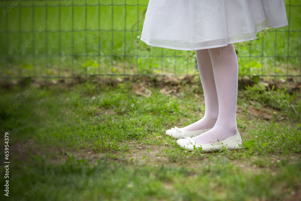 feet of little girl on the grass