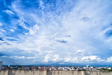 blue sky background with tiny clouds and cityscape on top view