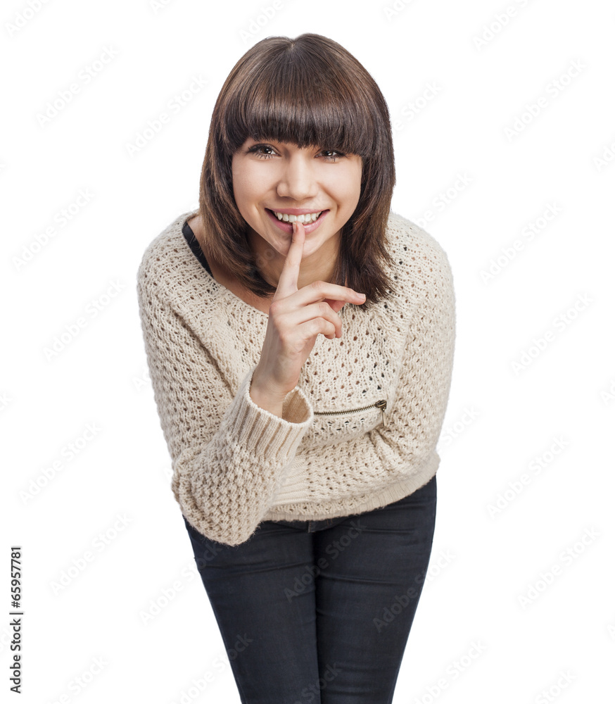 portrait of a pretty young woman doing silence gesture