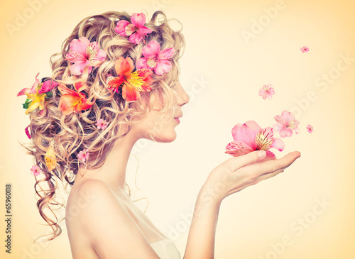 Beauty girl takes beautiful flowers in her hands