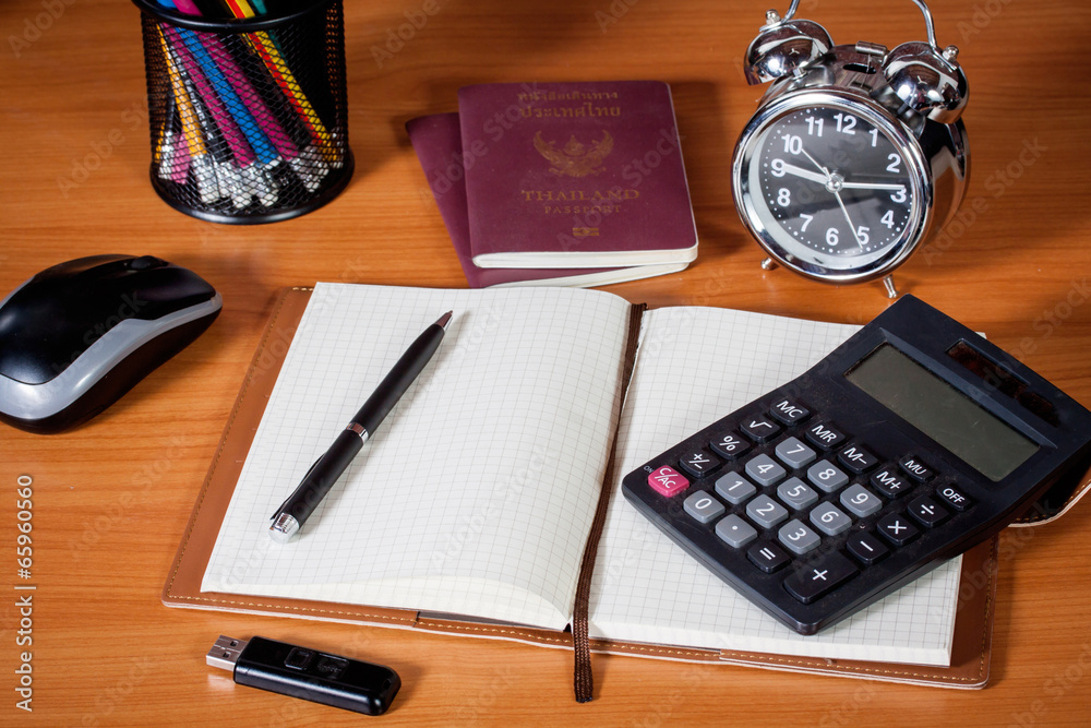 Workplace with notebook, and alarm clock on work table. Workplace with notebook, and alarm clock on work table.
