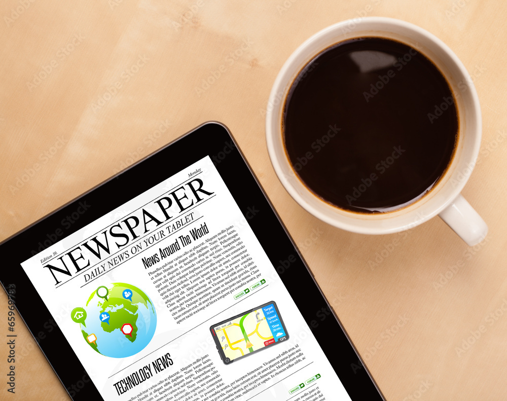 Tablet pc shows news on screen with a cup of coffee on a desk Tablet pc shows news on screen with a cup of coffee on a desk