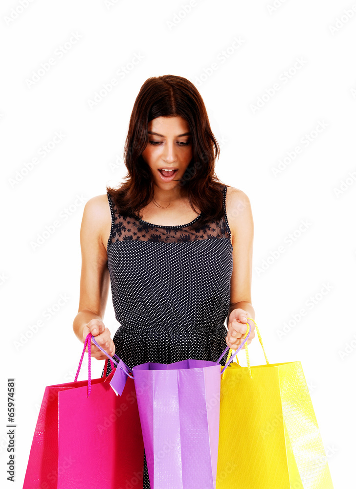 Girl looking in shopping bag. Girl looking in shopping bag.