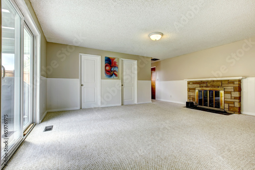 Empty room with fireplace and walkout deck