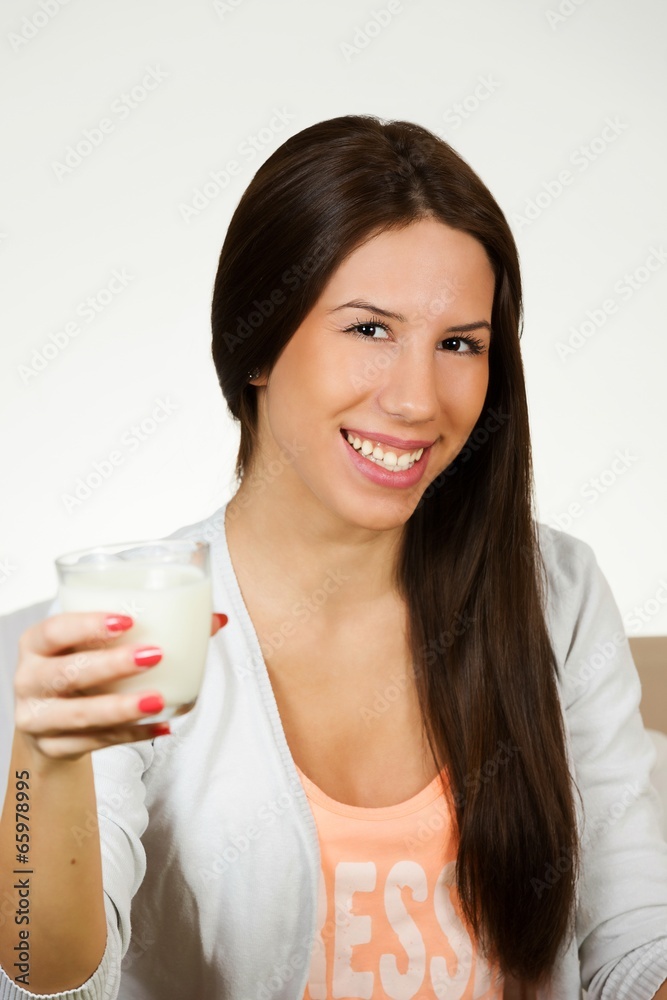 Beautiful young woman drinking milk, isolated on white Beautiful young woman drinking milk, isolated on white