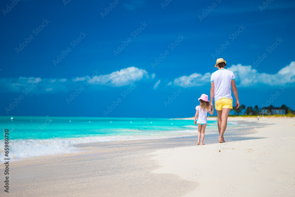 Happy father and his cute little daughter at beach Happy father and his cute little daughter at beach