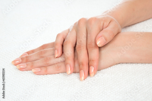Beautiful woman hands with french manicure nails