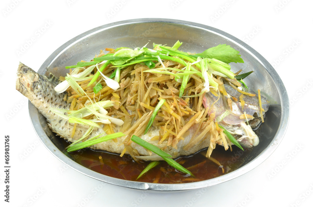 Steamed fish with soy sauce isolated on a white background Steamed fish with soy sauce isolated on a white background