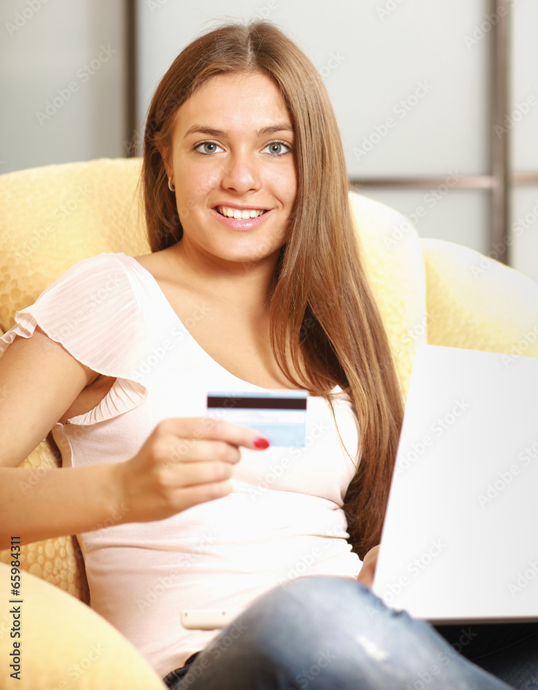 Beautiful happy smiling woman sitting on the sofa with laptop Beautiful happy smiling woman sitting on the sofa with laptop