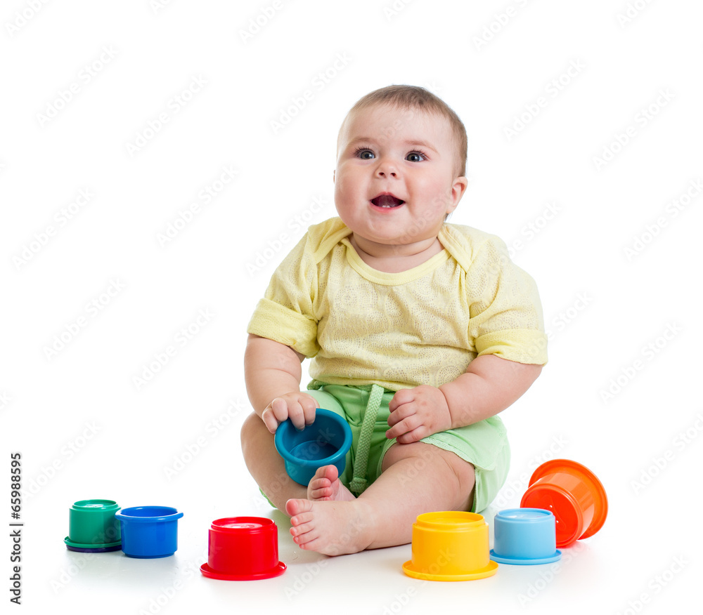 Funny little child is playing with toys while sitting on floor Funny little child is playing with toys while sitting on floor