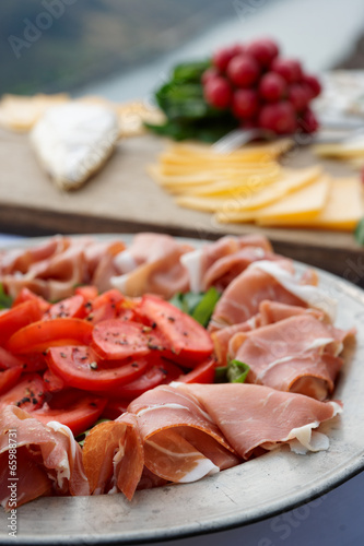 Platter with cured ham on table