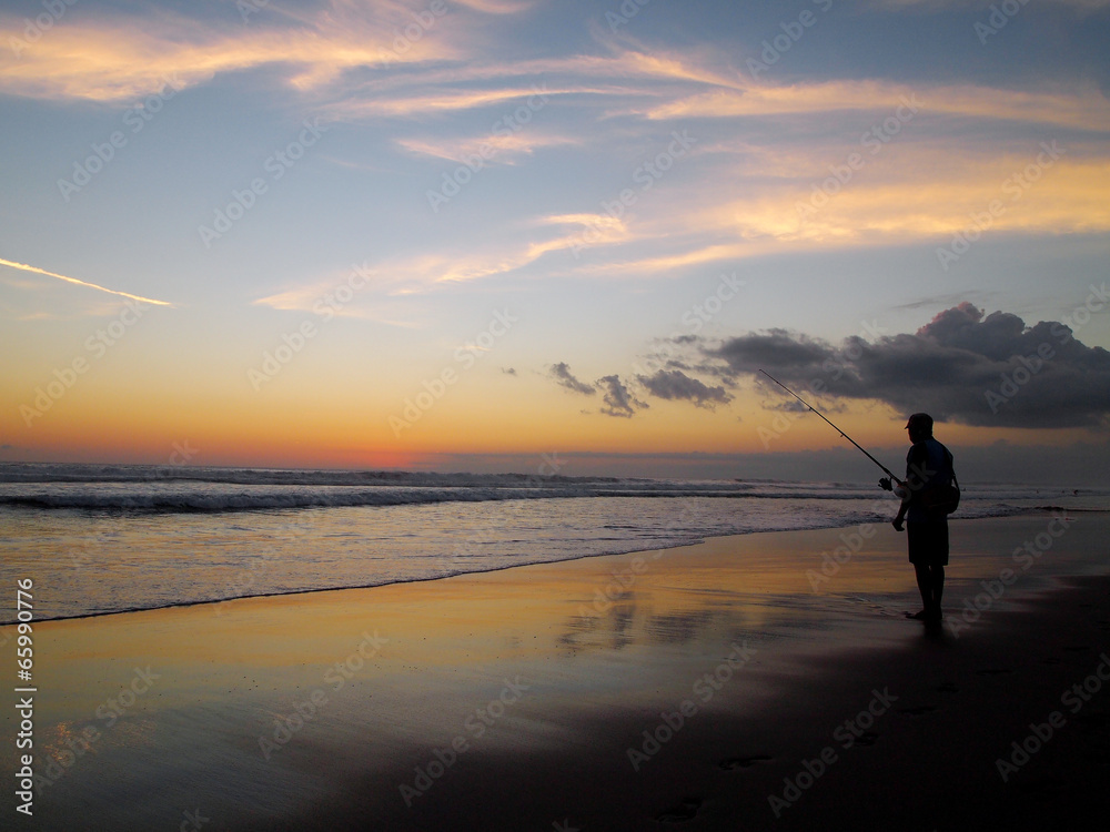 Sunset, beach and fishing man