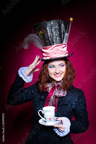 Portrait of smiling young woman in the similitude of the Hatter