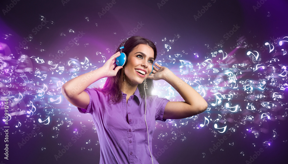 Pretty young woman with headphones listening to music