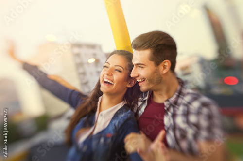 Happy couple riding in the amusement park- shoot with lensbaby photo