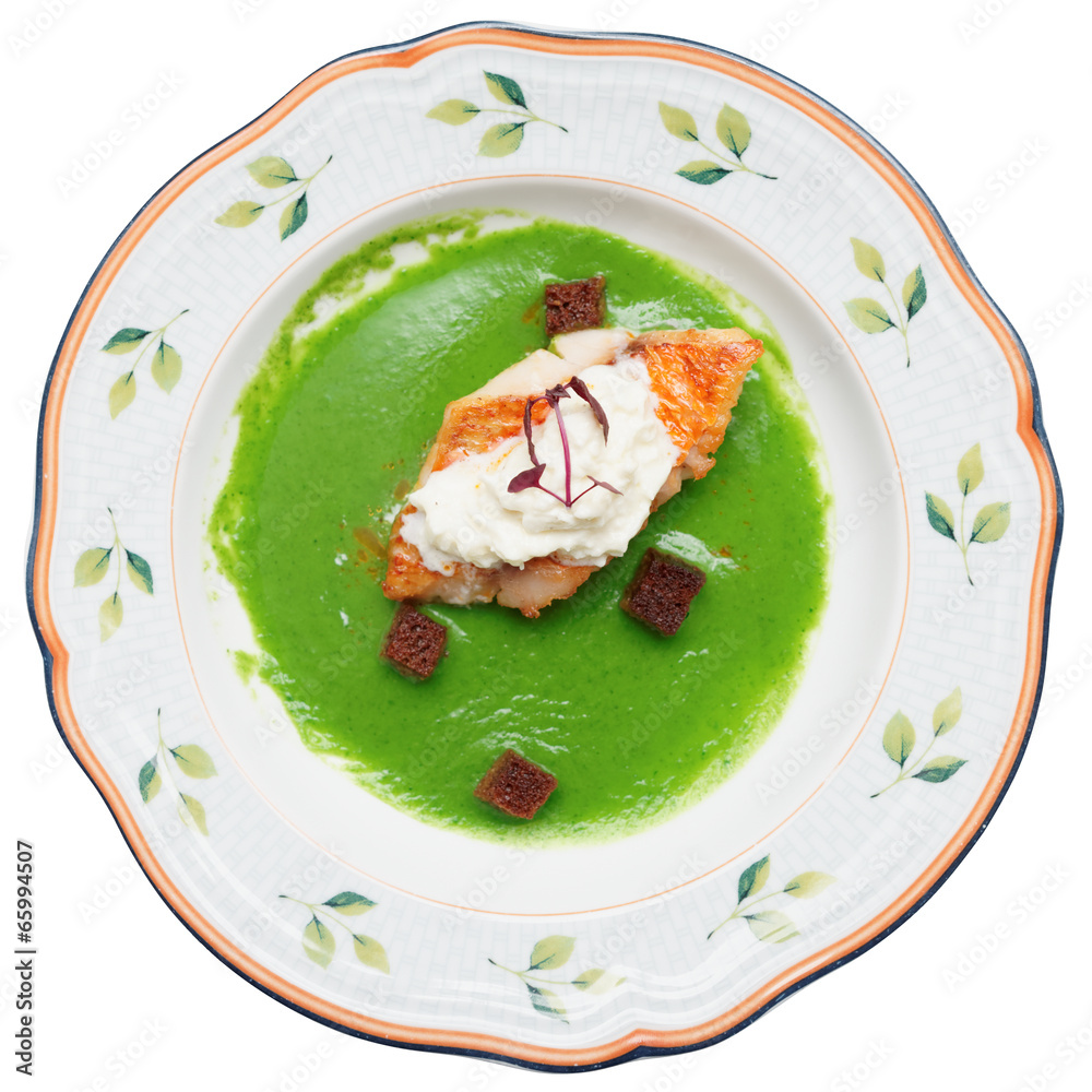 Seabass with herbs and spinach puree isolated on white Seabass with herbs and spinach puree isolated on white