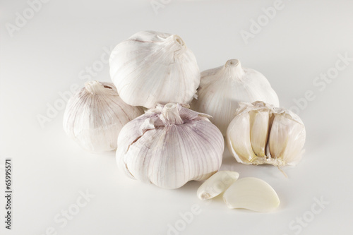 Garlic and slices on white background