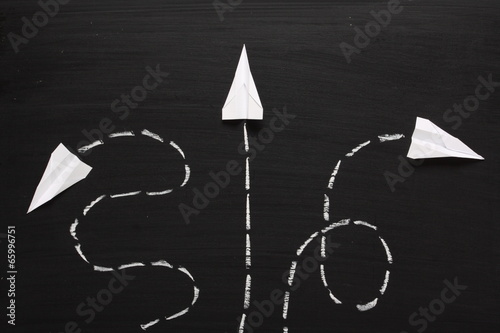Φωτογραφία Three paper airplanes take flight across a blackboard