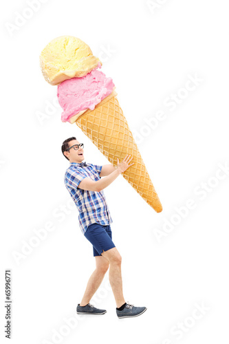 Cheerful young man carrying an enormous ice cream