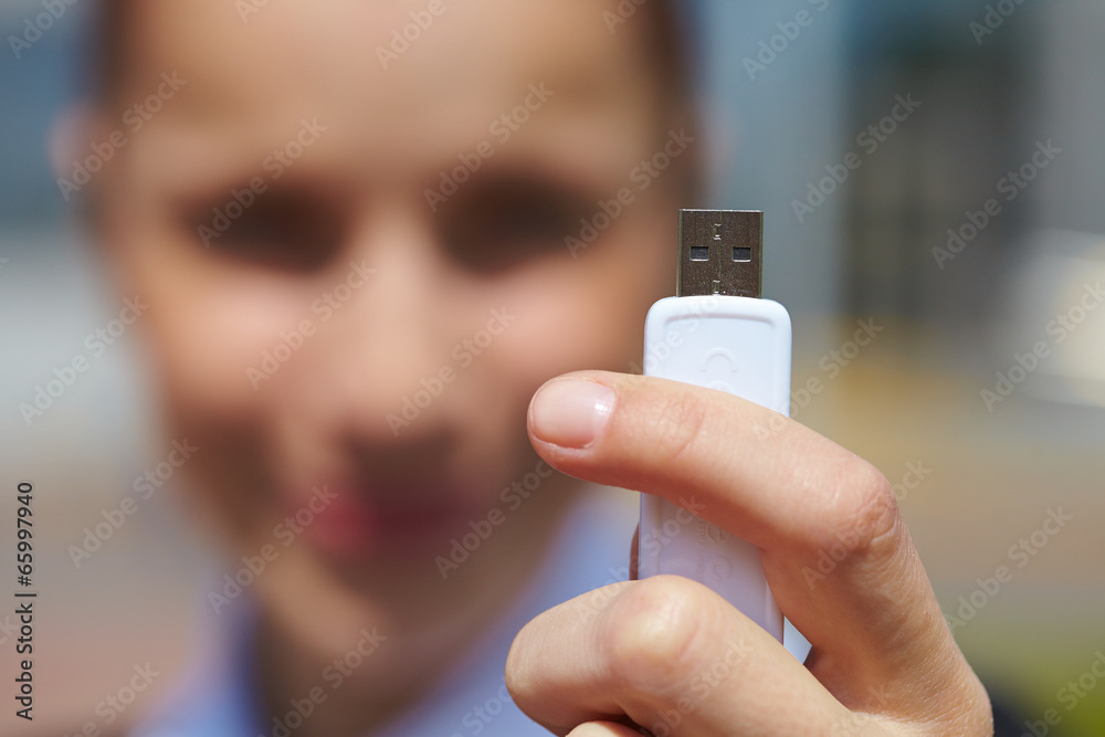 Fototapeta premium hand holding black USB data storage
