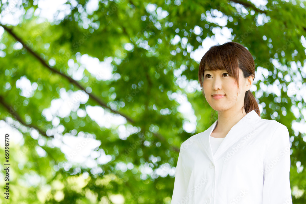 young asian doctor relaxing on green background young asian doctor relaxing on green background