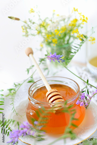 Jar full of honey and wildflowers