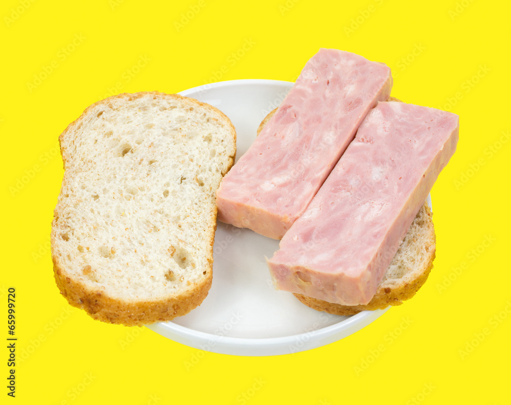 Processed ham sandwich on yellow background