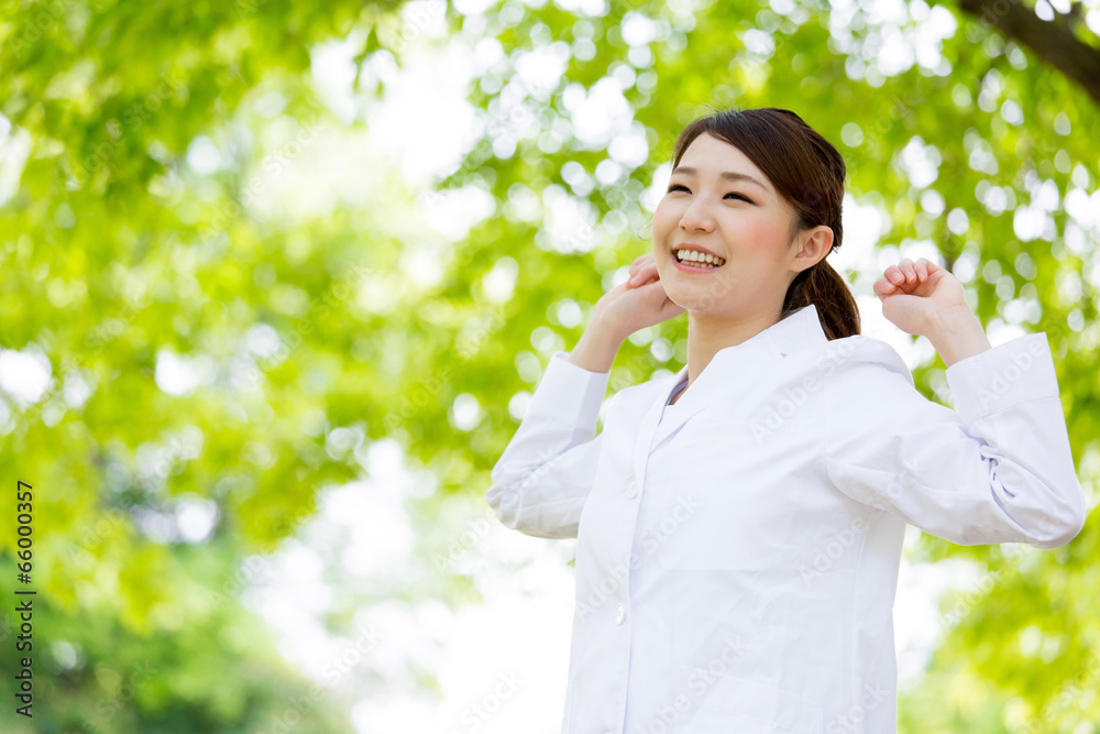 young asian doctor relaxing on green background young asian doctor relaxing on green background