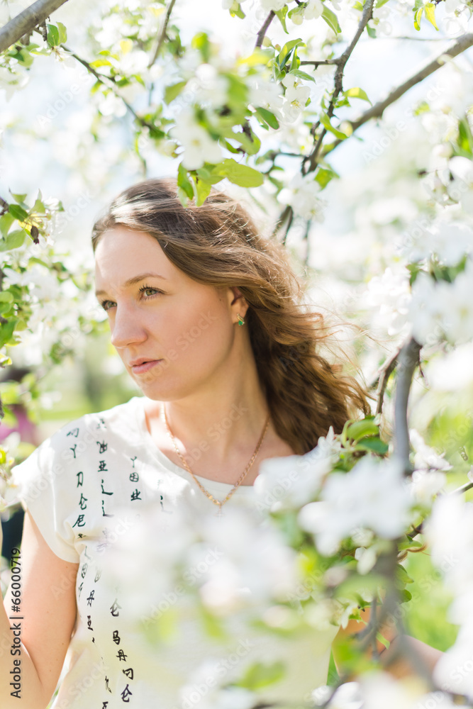 beautiful young brunette woman standing near the apple tree on a beautiful young brunette woman standing near the apple tree on a