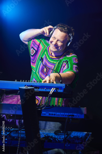 Happy mid age musician playing on a keyboard © paffy
