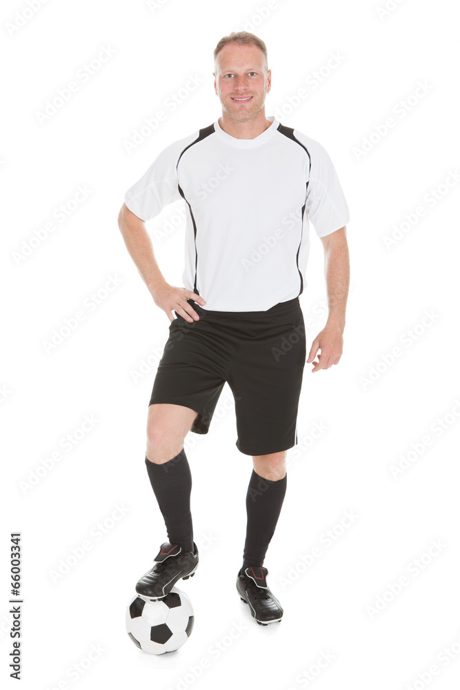 Confident Player With Leg On Soccer Ball