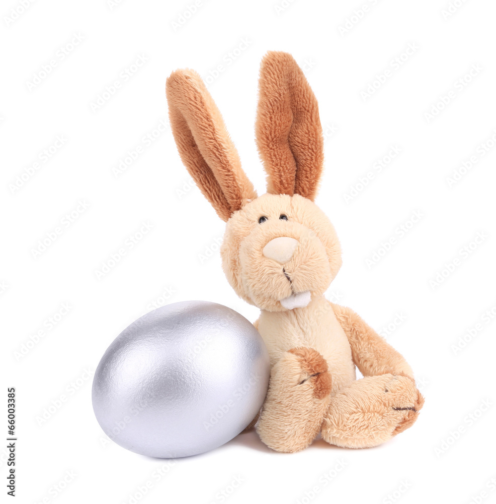 White toy rabbit with silver egg. White toy rabbit with silver egg.