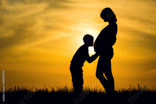 Silhouette pregnant and her son © lighthousestock
