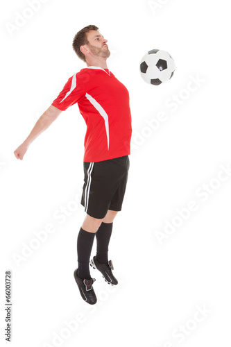 Player Hitting Soccer Ball With Chest © Andrey Popov