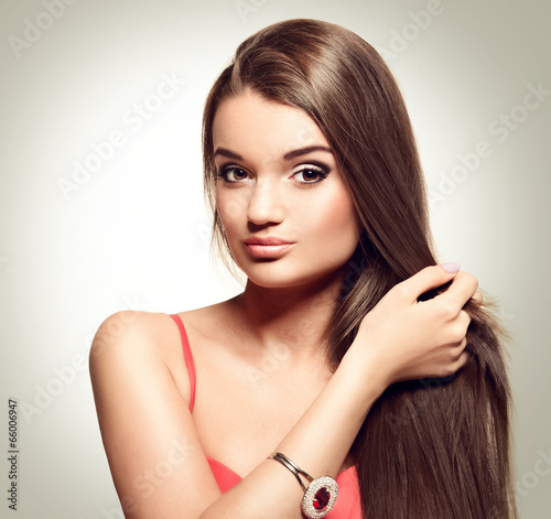portrait of beautiful young woman with long healthy brown hair.