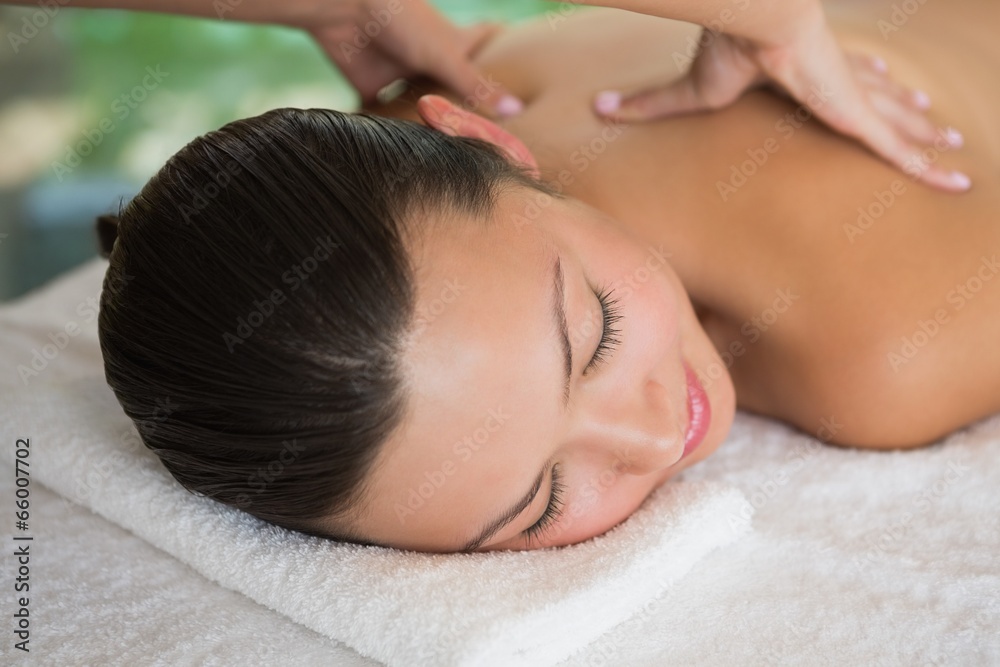 Brunette enjoying a peaceful massage with eyes closed Brunette enjoying a peaceful massage with eyes closed