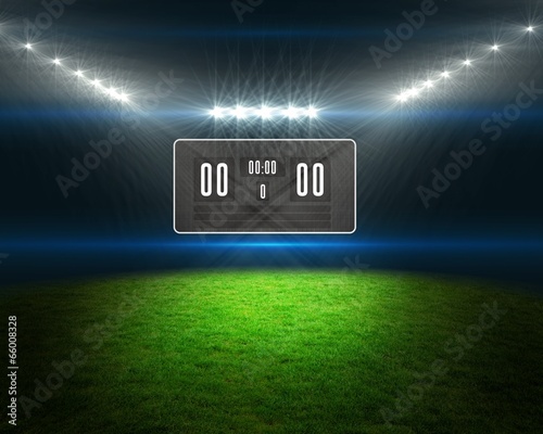 Football pitch with scoreboard and lights