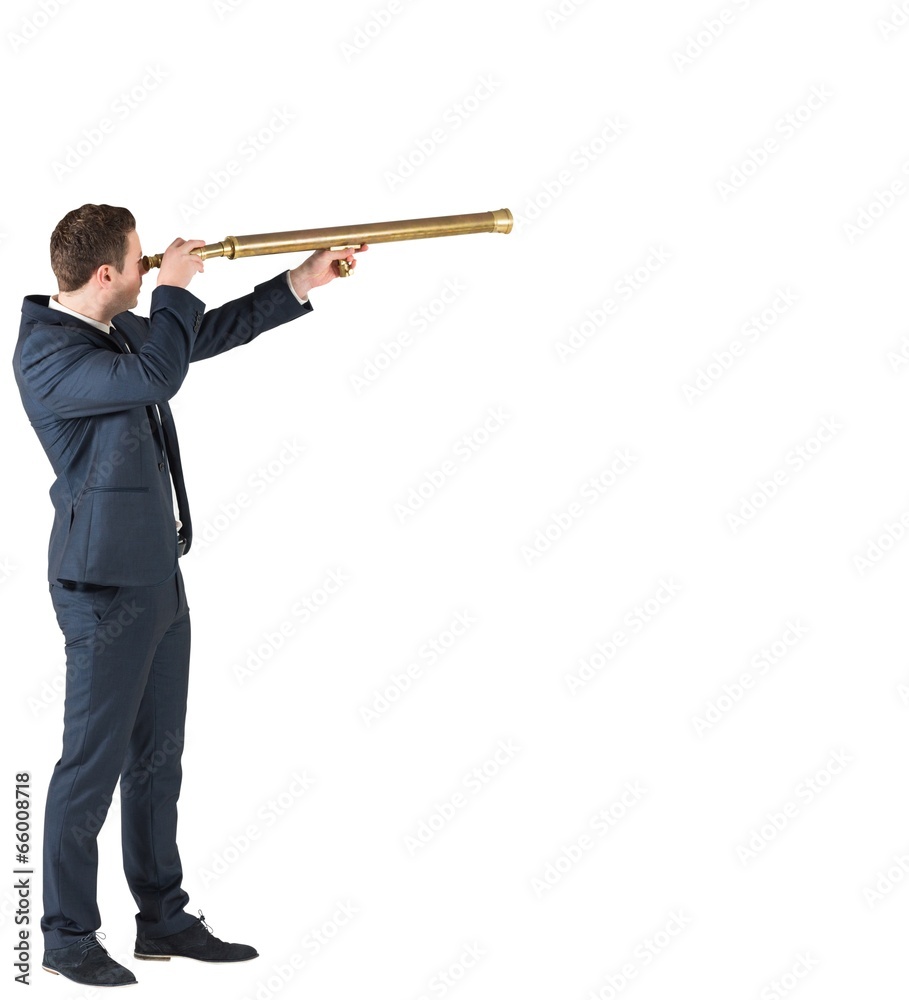 Businessman standing and looking through telescope Businessman standing and looking through telescope