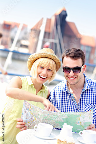 Young couple pointing at map