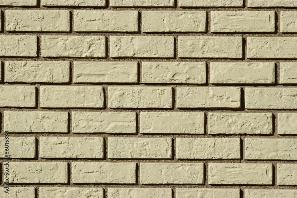 Wall made of white bricks with dark seams Wall made of white bricks with dark seams