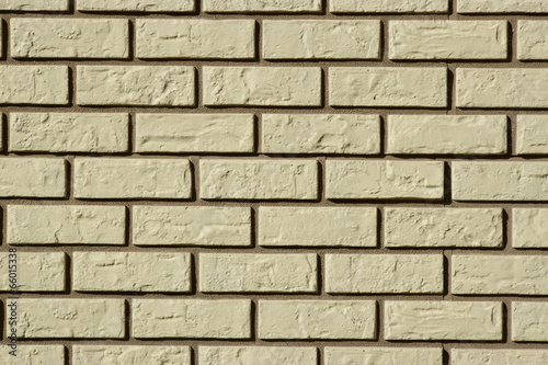 Wall made of white bricks with dark seams