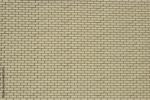 Wall made of white bricks with dark seams