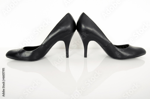 Black high heel woman shoes.Pair of black stillettos on white.