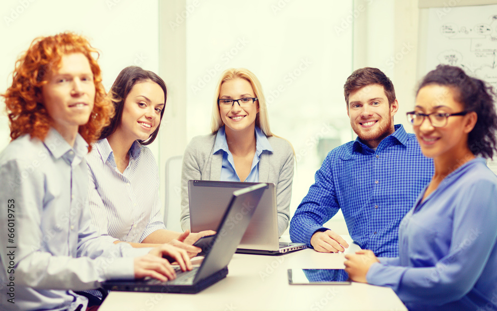 smiling team with laptop and table pc computers smiling team with laptop and table pc computers